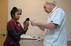 Pet Exams and Wellness Care in Pasadena, TX: Veterinarian and technician performing exam